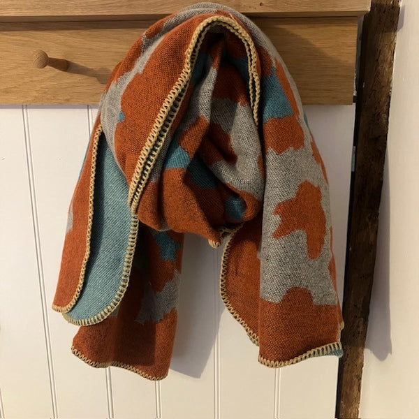The Etta Cape Rust & Turquoise is an absolutely stunning leopard print accessory to add to your wardrobe