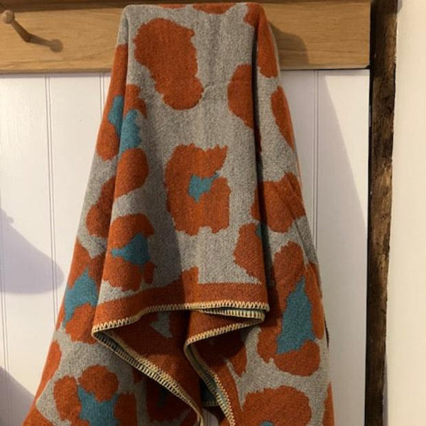 The Etta Cape Rust & Turquoise is an absolutely stunning leopard print accessory to add to your wardrobe