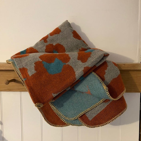 The Etta Cape Rust & Turquoise is an absolutely stunning leopard print accessory to add to your wardrobe