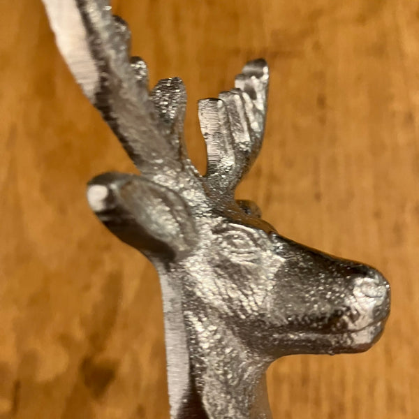 The Stag Candle Snuffer extinguishes a candles flame safely