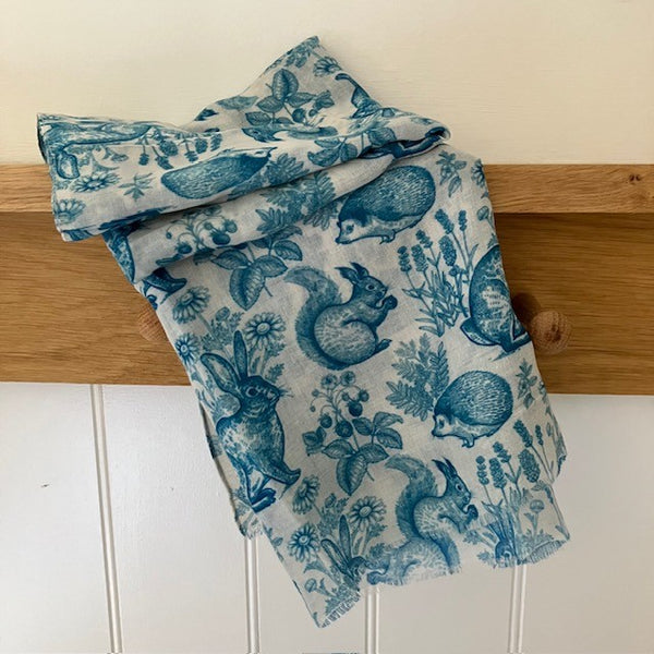 The Cottage Wildlife Scarf Teal is a cosy British cottage garden print including wildlife