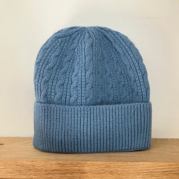 The Agnes Hat in Light Blue has a good stretch and a knitted pattern