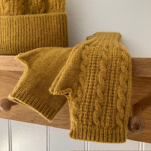 The Agnes Fingerless Gloves have a knitted pattern one side and plain the other