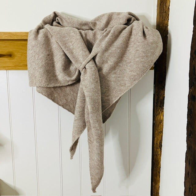 The Aida Scarf Natural has a useful loop feature to secure the scarf on your shoulders