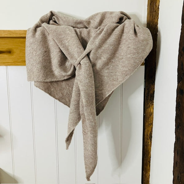 The Aida Scarf Natural has a useful loop feature to secure the scarf on your shoulders