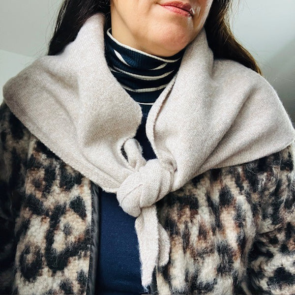 The Aida Scarf Natural can be folded into a smaller triangular shape