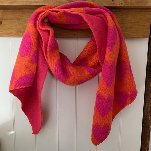 The Amora Scarf Orange and Pink has plenty of soft material to be worn in several different styles