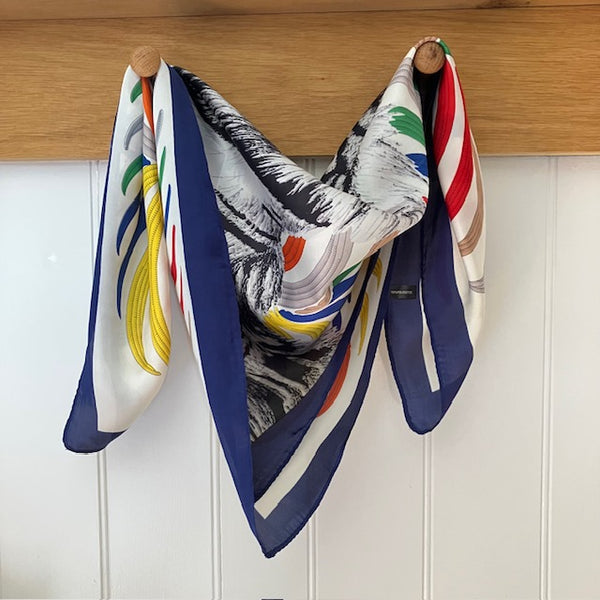 The Babar Scarf Blue is a small square with a fabulous bold tiger design. Ideal for styling into the on-trend small neck and triangle tied scarves.