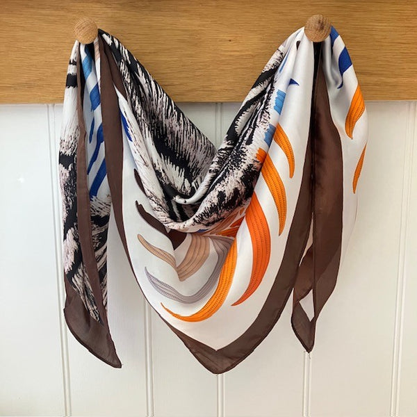 The Babar Scarf Brown is a small square with a fabulous bold tiger design. Ideal for styling into the on-trend small neck and triangle tied scarves.