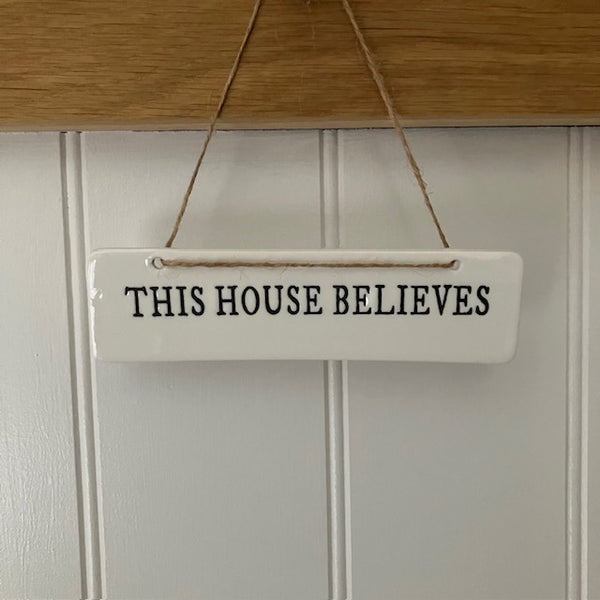 The This House Believes Sign is a super cute little ceramic hanging decoration