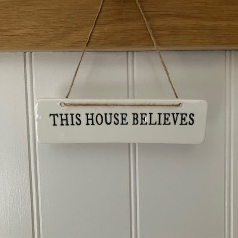 The This House Believes Sign is a super cute little ceramic hanging decoration