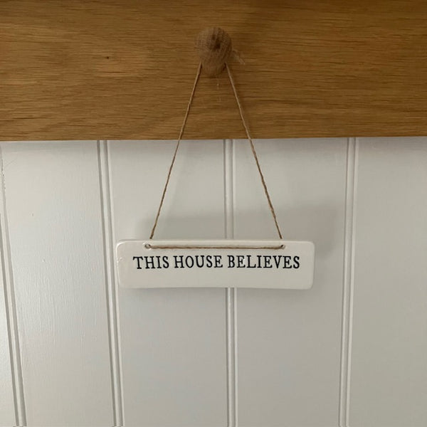 The This House Believes Sign is a super cute little ceramic hanging decoration