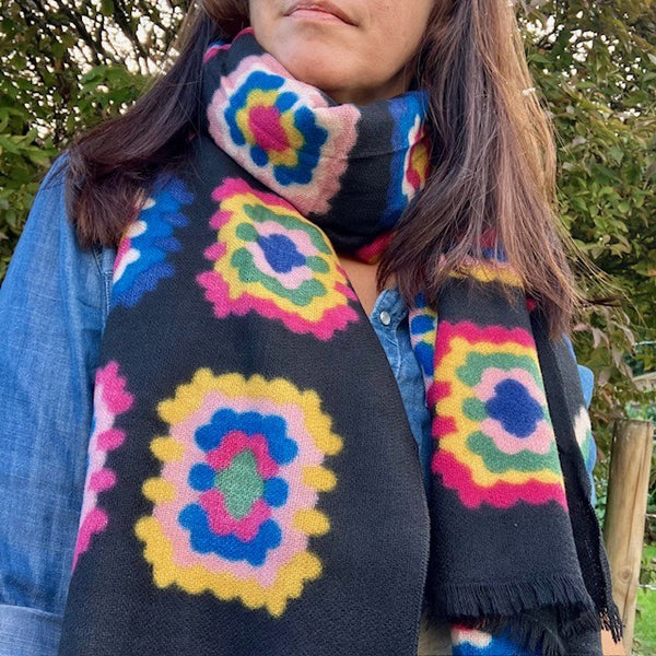 The Betsy Scarf is a long rectangular scarf with frayed ends