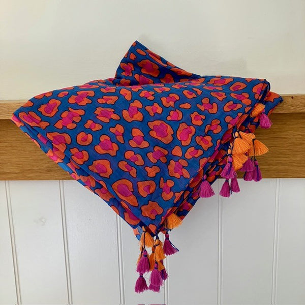 The Cari Scarf is a denim blue in colour with striking coral and pinks