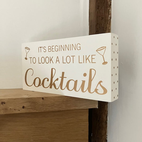 Block sign with fun "It's Beginning to Look A Lot Like Christmas" text in gold 