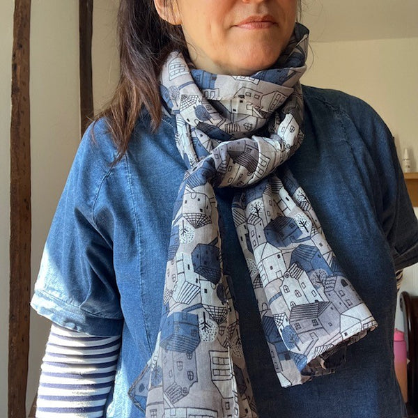 The Cosy Town scarf has a fabulous repeating pattern of little houses in navy, grey and white 