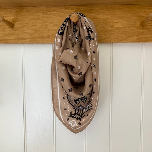 The Dolly Scarf Taupe features a fabulous western style pattern of stars, dots, paisley and small flowers giving it that lovely cowgirl look that's so on trend at the moment