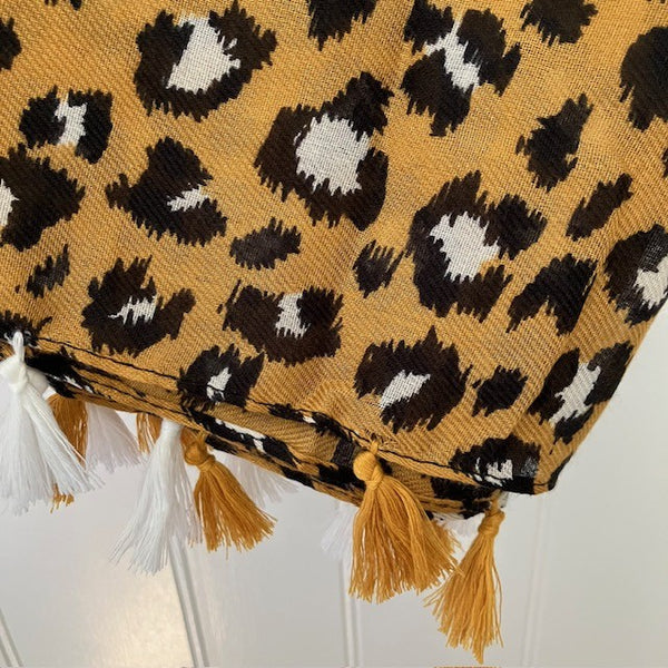 The Elora Scarf Camel has a tassel detail on the ends of the scarf