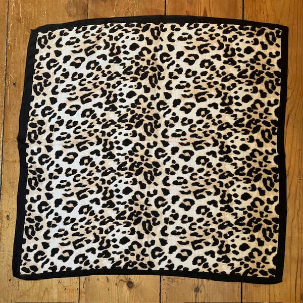 The Esper Scarf is a fabulous leopard print small square with a black border