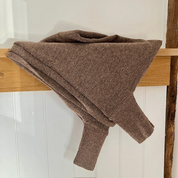 The Floella Poncho is Brown with light and dark colours to it