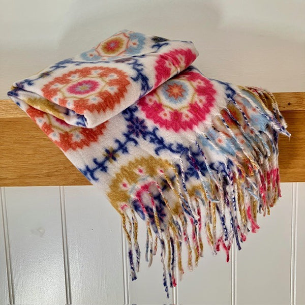 The Flossie Scarf is rectangular in shape with long tassels at the end