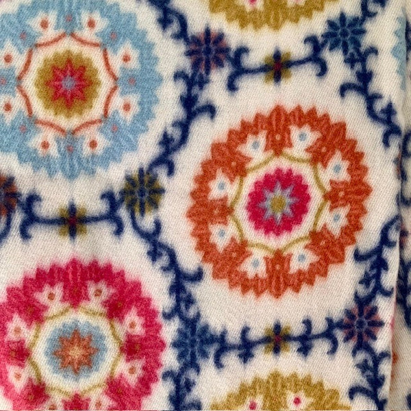 The Flossie Scarf has a circular floral pattern