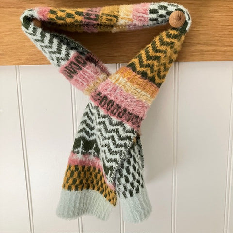 The Heather Scarf is a clever pull-through design that sits snug and cosy around your neck