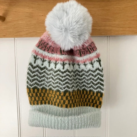 The Heather Hat is a wonderfully soft, cosy and warm pom pom style with a fabulous eye catching design