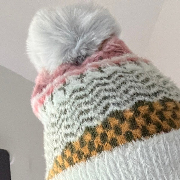 The Heather Hat has a faux fur pom pom