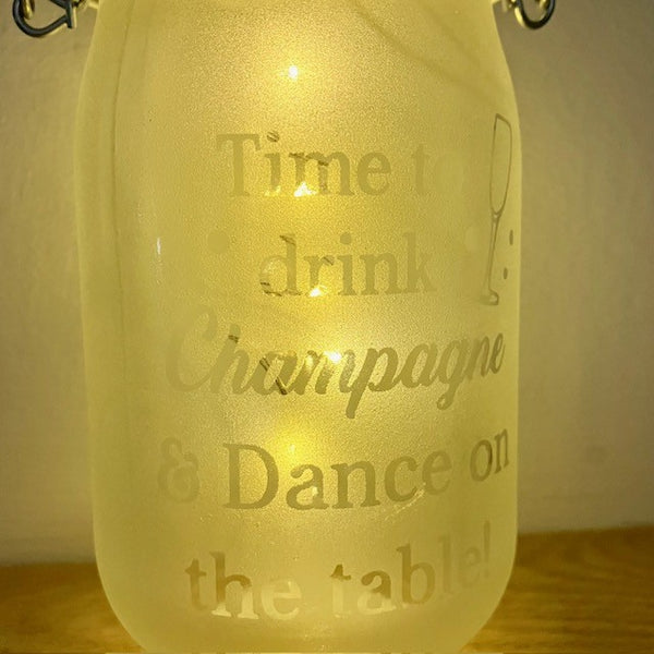 Close up of frosted glass that reads - Time to Drink Champagne & Dance on the Tables!