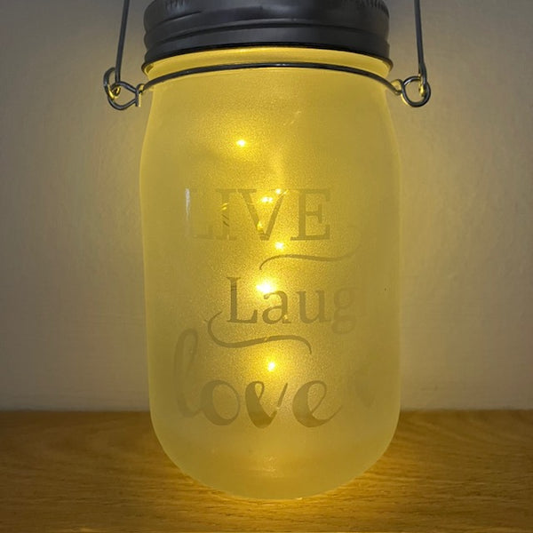 Close up of frosted glass that reads - Live Laugh Love