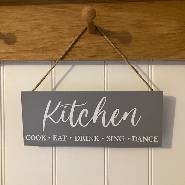 The Kitchen Sign will make the perfect gift for someone that loves to "Cook, Eat, Drink, Sing & Dance" in their kitchen