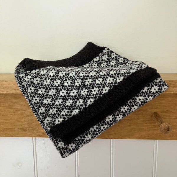 The Linnea Scarf is a unique pull through design in a pretty black and white flower pattern