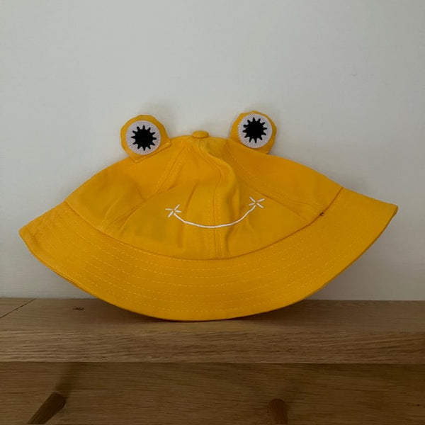 The Lolly Frog Bucket Hat Yellow is a super fun and cute sun hat for kids