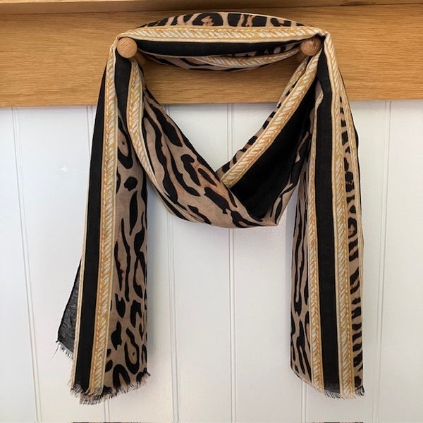 The Mari Leopard Print Black is a must have animal print scarf that will elevate any outfit