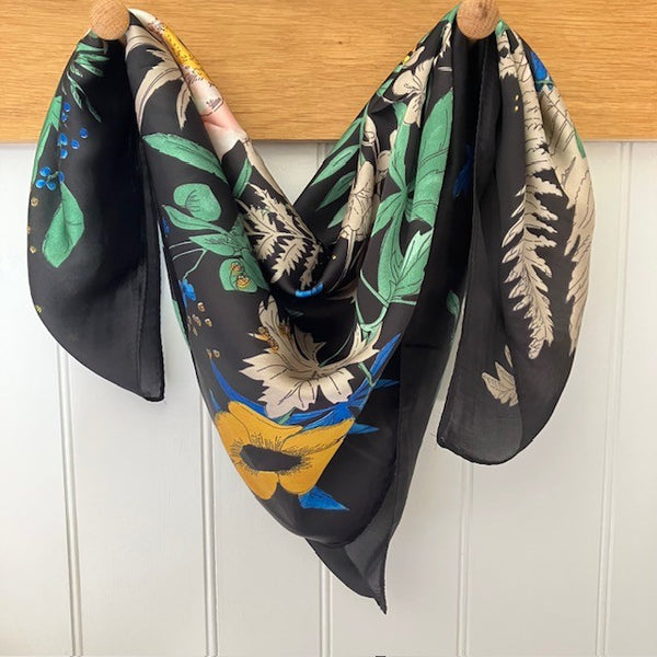 The Meadow Scarf Black is a small square with the most beautiful bold flower design. Ideal for styling into the on-trend small neck and triangle tied scarves.