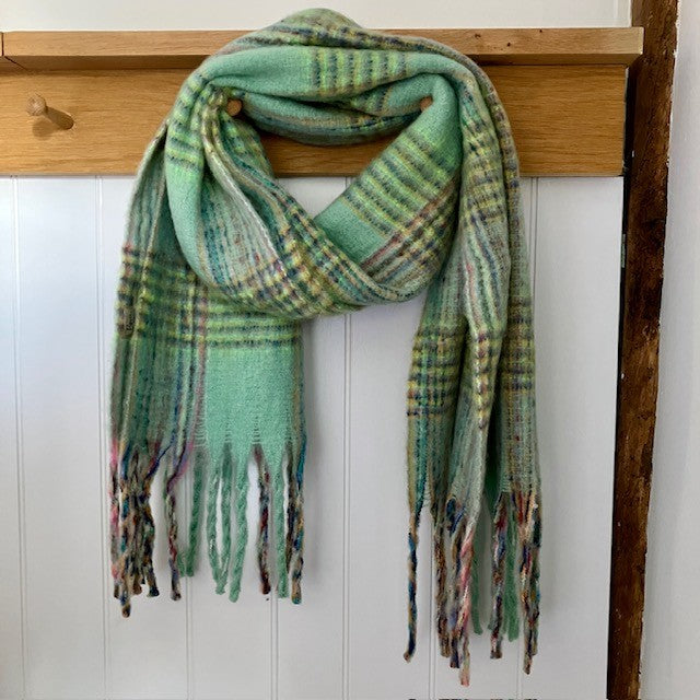 The Minty Scarf Green is a fabulous, on-trend large check statement scarf that will add warmth and character to any outfit