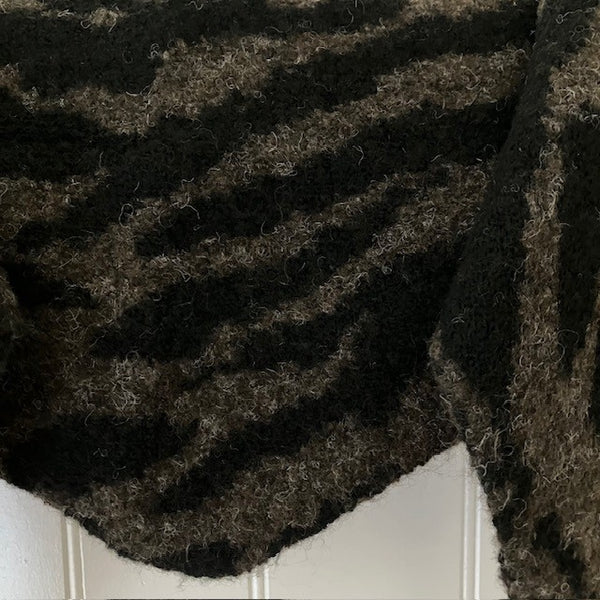 The Ophelia Scarf is a dark brown with black zebra print stripes