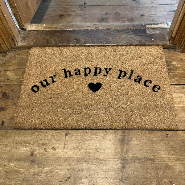 The Cosy Doormat 'Our Happy Place' will add a warm welcome to your home