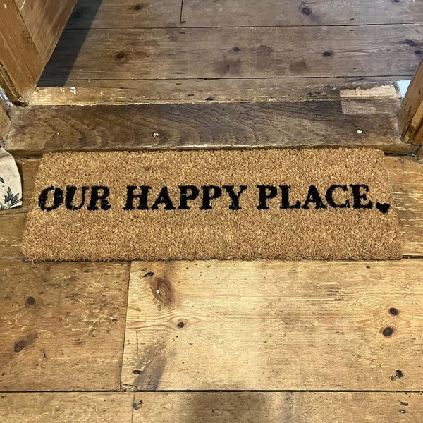 The Cosy Step Doormat 'Our Happy Place' will add a warm welcome to your home