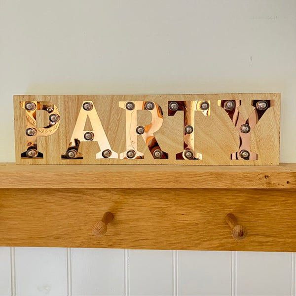 The Copper and Wood 'PARTY' Light Up Sign is a fabulous unique light box that will make a cosy light feature in your home