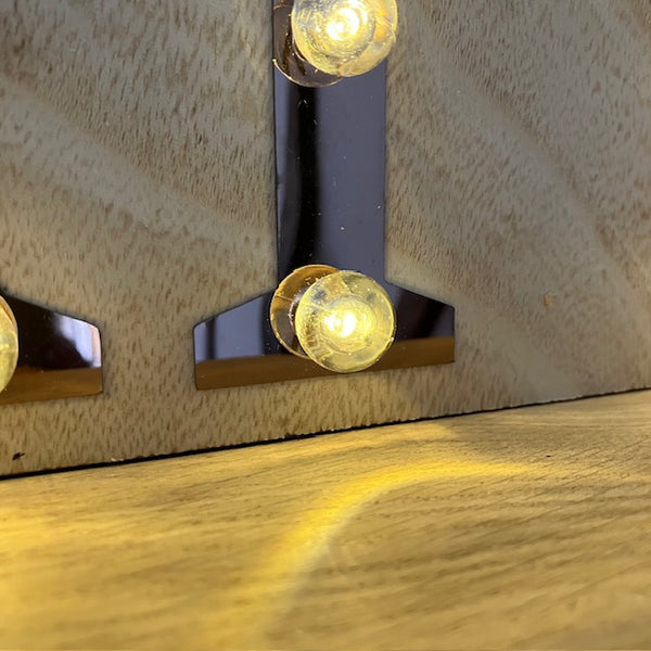 The Copper and Wood 'PARTY' Light Up Sign has a warm white LED bulbs.