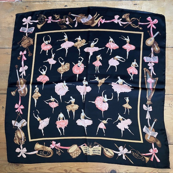 The Pavlova Scarf has a beautiful patter of dancing ballerinas and a border of musical instruments and bows