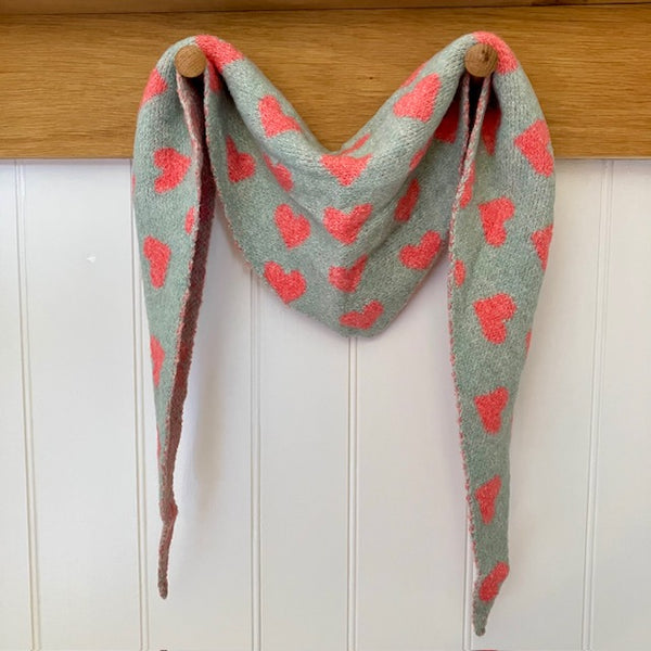 The Pixie Scarf Duck Egg Blue with little pink hearts is in the much sought after small knit triangle shape. Super cute and cosy accessory to add some fun and elevate an outfit.