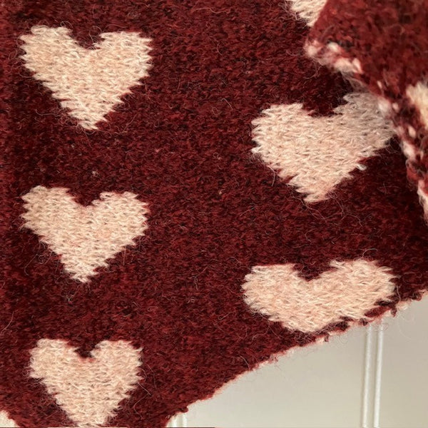 The Pixie Scarf Burgundy has a super cute love heart pattern on it 