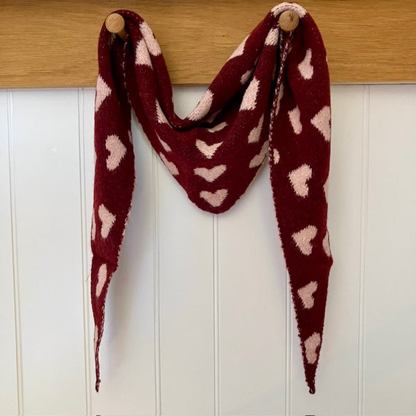The Pixie Scarf Burgundy with little pink hearts is in the much sought after small knit triangle shape.