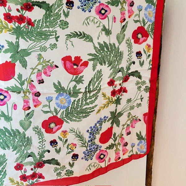 The Poppy Scarf has a bright red border