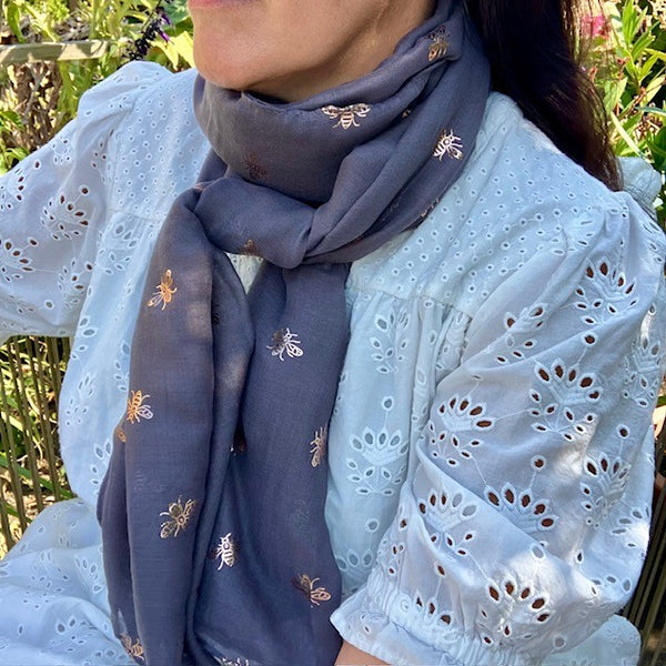 The Queenie Scarf is a long rectangular scarf that can be worn many ways 
