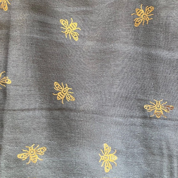 The Queenie Scarf has a rose gold bee pattern all over