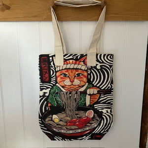 The Ramen Cat Tote Bag is a fabulous unique design with a wave patterned background and Ramen eating Ninja Cat!